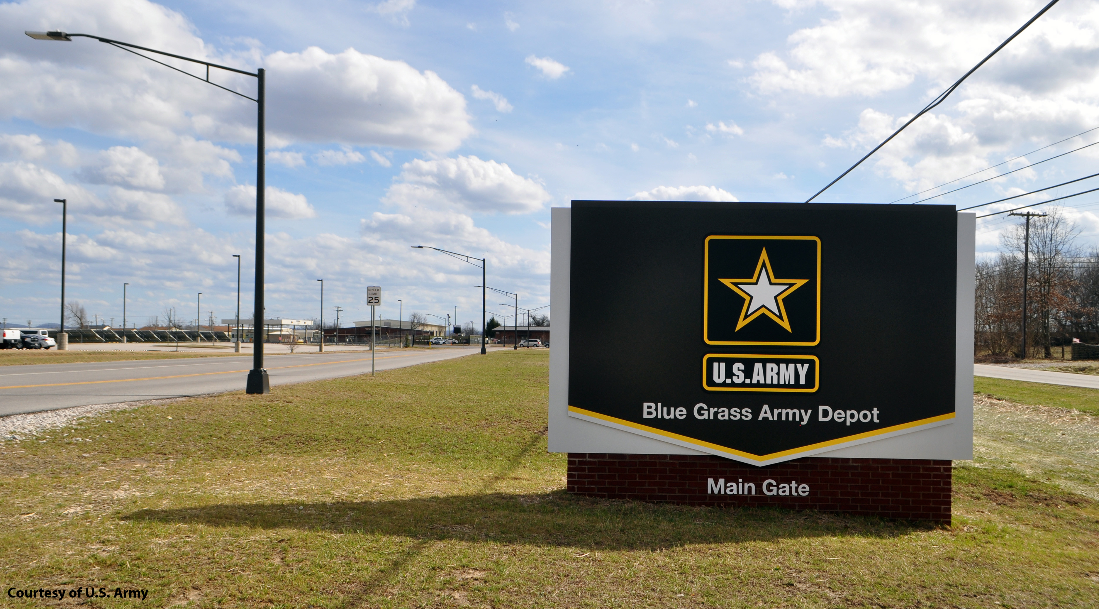Black Entrance Sign to the Blue Grass Army Depot Main Gate. There is a large yellow and white star and yellow square around it, making the U.S. Army logo.